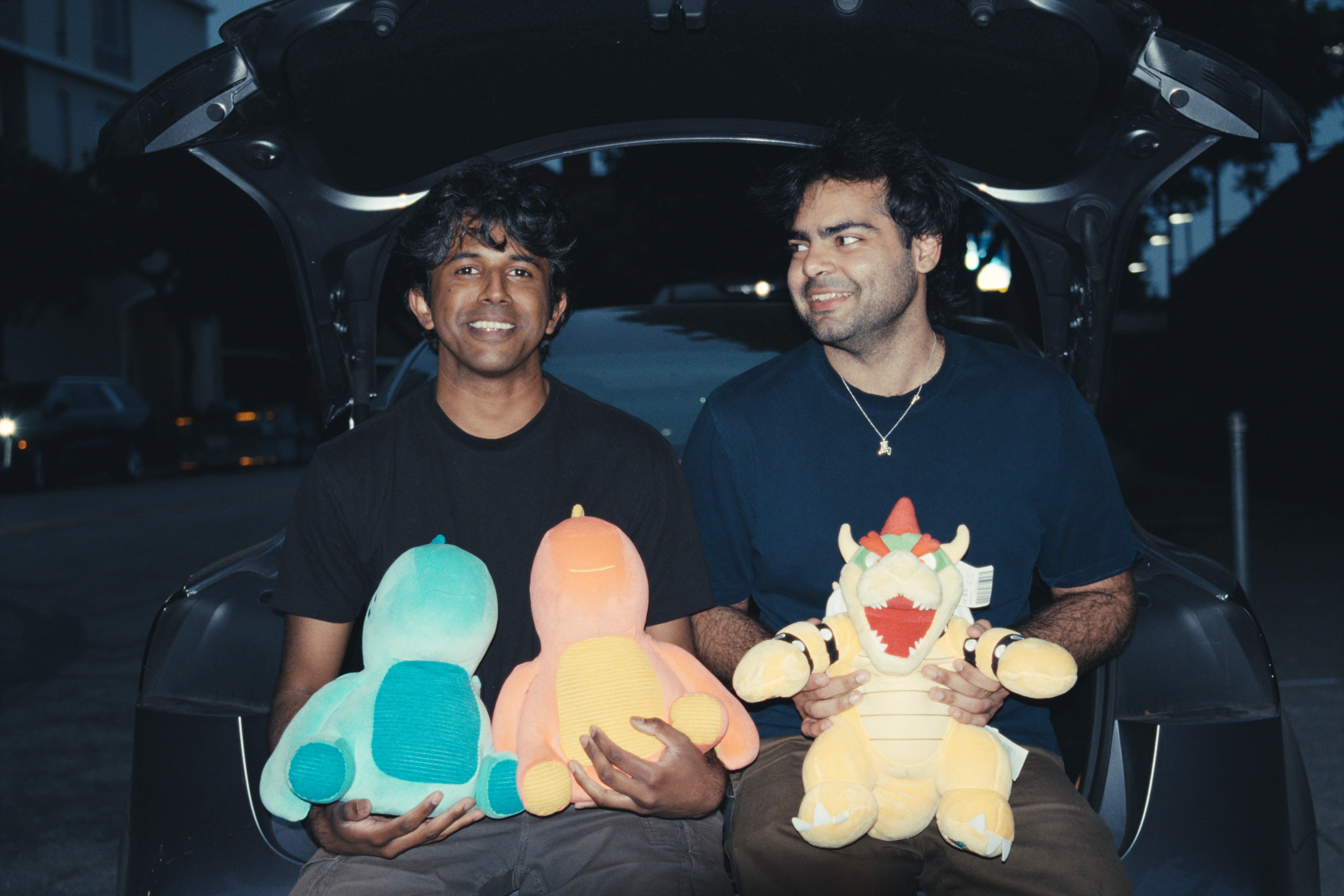 Subby and Aadil sitting in a trunk